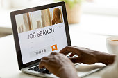 African-american man browsing work online using job search computer app