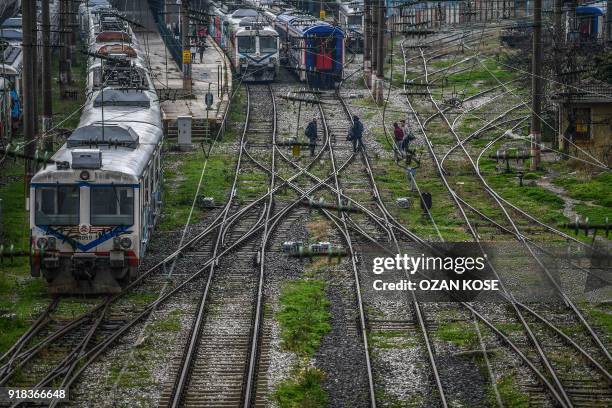 Picture taken on January 15, 2018 shows scrap trains decorated with graffitis at the Haydarpasa train station in Istanbul. Built in the first decade...