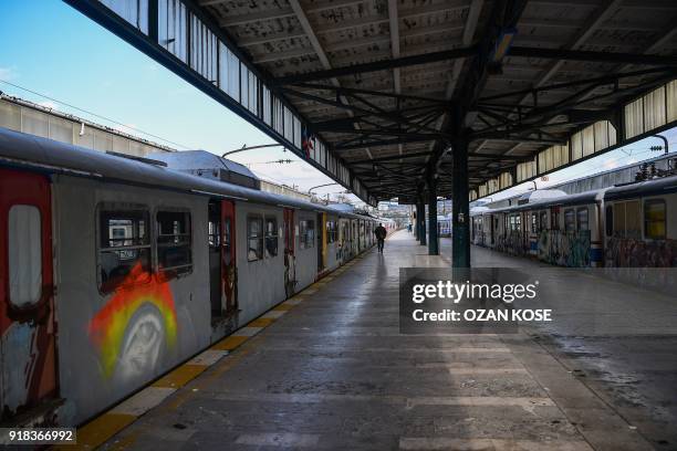 Picture taken on January 15, 2018 shows scrap trains decorated with graffitis at the Haydarpasa train station in Istanbul. Built in the first decade...