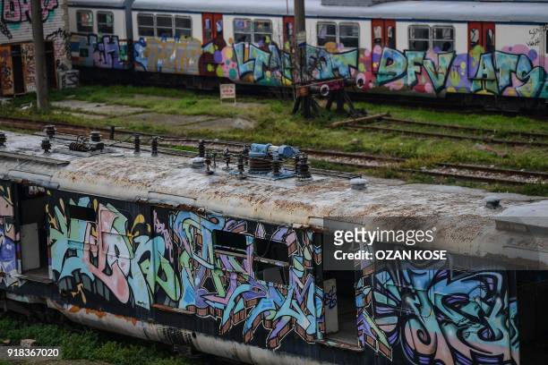 Picture taken on January 15, 2018 shows scrap trains decorated with graffitis at the Haydarpasa train station in Istanbul. Built in the first decade...