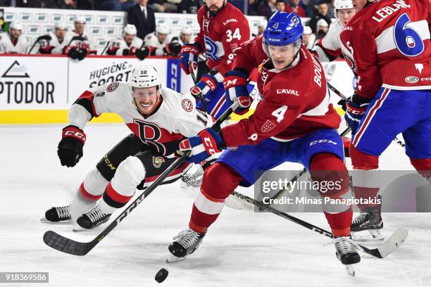 Simon Bourque of the Laval Rocket skates the puck against Jack Rodewald of the Belleville Senators during the AHL game at Place Bell on February 14,...