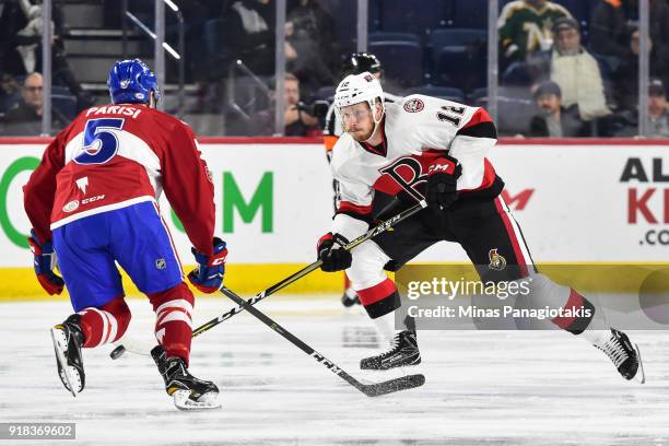 Jack Rodewald of the Belleville Senators skates the puck against Tom Parisi of the Laval Rocket during the AHL game at Place Bell on February 14,...