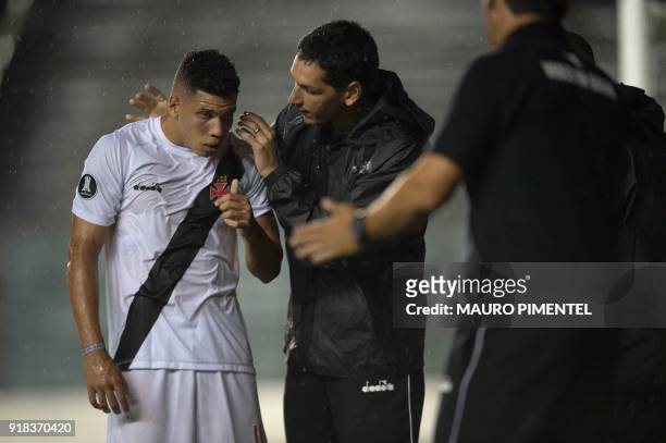 Brazil's Vasco da Gama player Paulinho receives medical attention after colliding with the goalkeeper of Bolivia's Jorge Wilstermann while he scored...