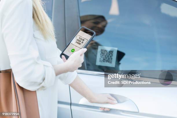 woman scans qr code using ride share app - car sharing stock pictures, royalty-free photos & images