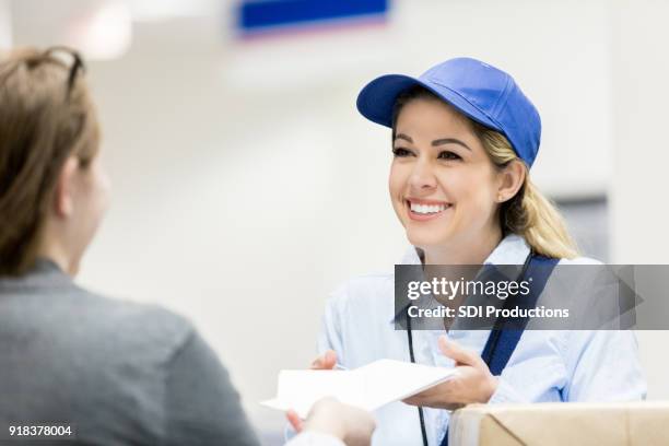 vertrouwen vrouwelijke bezorger de besprekingen met klant - postbode stockfoto's en -beelden