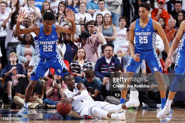 Jared Harper of the Auburn Tigers falls to the floor while defended by Shai Gilgeous-Alexander of the Kentucky Wildcats in the first half of a game...