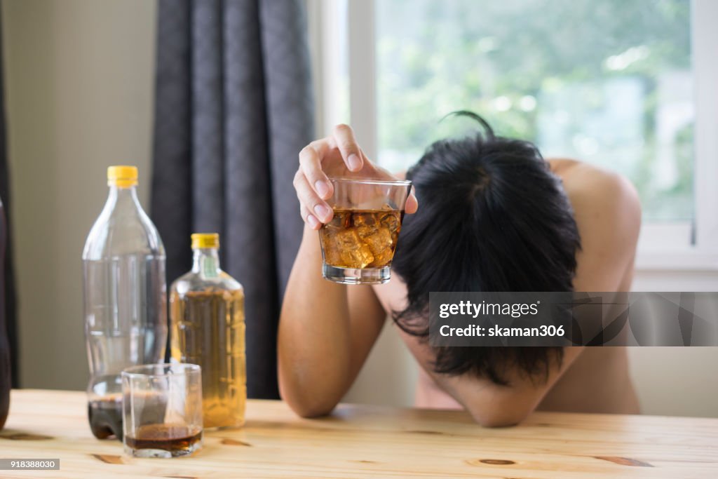 Asian man drink whiskey and Alcohol dependence