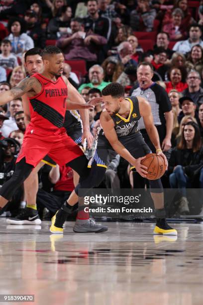 Damian Lillard of the Portland Trail Blazers defends against Stephen Curry of the Golden State Warriors during the game between the two teams on...