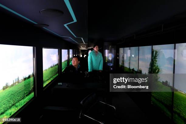 Employees sit onboard an autonomous 5G connected bus, operated by KT Corp., as it travels along a road during a media event in Gangneung, Gangwon...