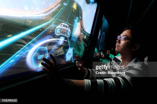 An employee plays a video game onboard an autonomous 5G connected bus, operated by KT Corp., as it travels along a road during a media event in...