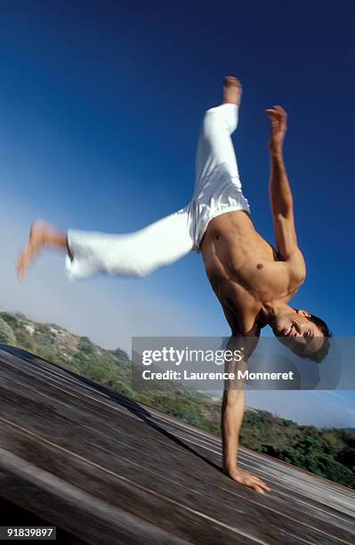 man balancing on hand - noordhoek stock-fotos und bilder