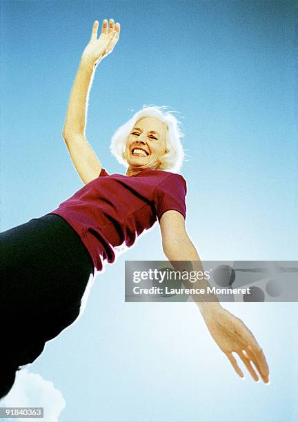 smiling woman dancing - young at heart woman stock pictures, royalty-free photos & images