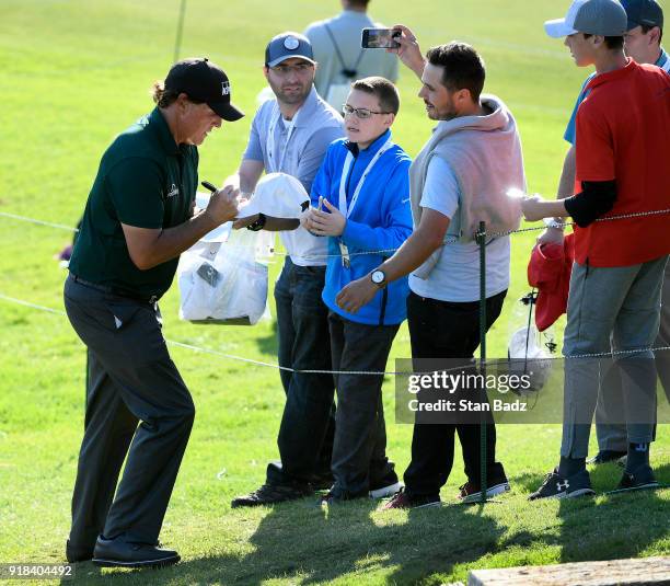 Phil Mickelson signs autographs for fans during the Pro-Am round for the Genesis Open at Riviera Country Club on February 14, 2018 in Pacific...