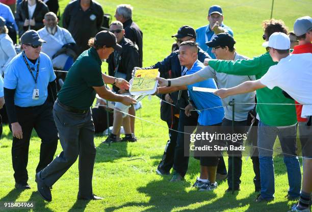 Phil Mickelson signs autographs for fans during the Pro-Am round for the Genesis Open at Riviera Country Club on February 14, 2018 in Pacific...