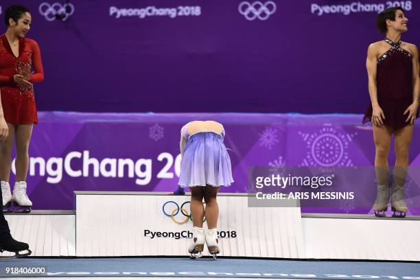 Germany's Aljona Savchenko reacts on the podium for winning gold with partner Germany's Bruno Massot, as silver winner China's Sui Wenjing and bronze...