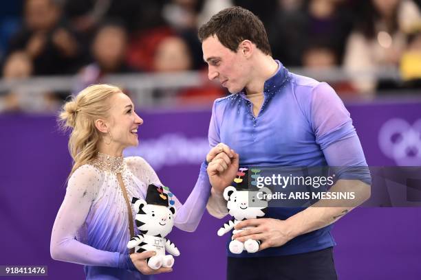 Germany's Aljona Savchenko and Germany's Bruno Massot react on the podium during the venue ceremony after the pair skating free skating of the figure...