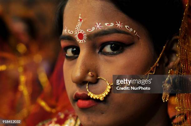Indian brides wait for final make-up prior to go to a temporary marriage hall during a mass-marriage ceremony in Kolkata on February 14, 2018. More...