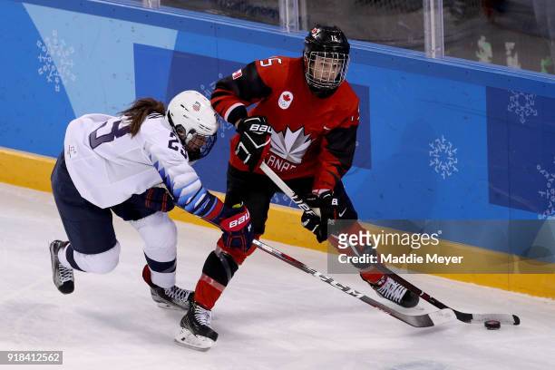 Sidney Morin of the United States and Melodie Daoust of Canada compete for the puck during the Women's Ice Hockey Preliminary Round Group A game on...