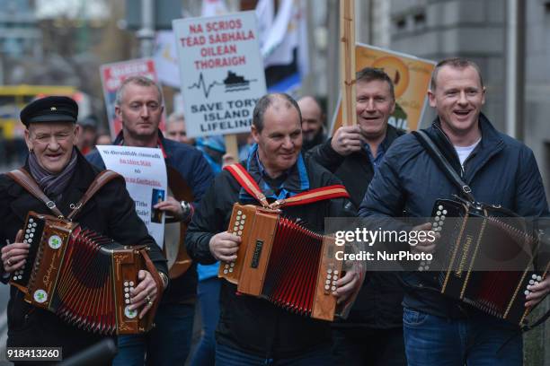 People from mainly Irish-speaking Tory Island protest outside Leinster House in Dublin against the government's decision to award a contract for a...