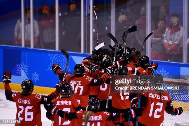 Canada's players celebrate winning the women's preliminary round ice hockey match between the US and Canada during the Pyeongchang 2018 Winter...