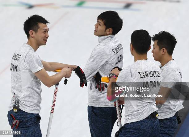 Kosuke Morzumi, Tetsuro Shimizu, Yusuke Morozumi and Tsuyoshi Yamaguchi of Japan talk during the Curling Men's Round Robin Session 3 held at...