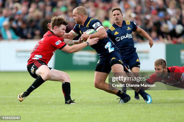 Matt Faddes of the Highlanders fends off Mitch Drummond of the Crusaders during the Super Rugby trial match between the Highlanders and the Crusaders...