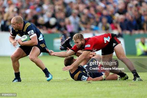 Matt Faddes of the Highlanders breaks the tackle of Braydon Ennor of the Crusaders during the Super Rugby trial match between the Highlanders and the...