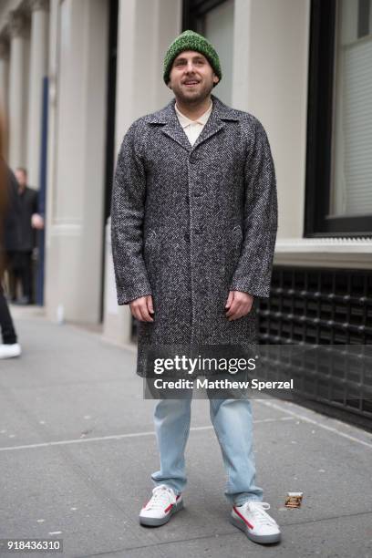 Jonah Hill is seen on the street attending EDUN during New York Fashion Week wearing a grey wool coat with green beanie on February 14, 2018 in New...