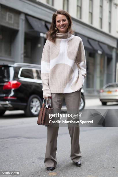 Christy Turlington is seen on the street attending EDUN during New York Fashion Week wearing a beige/white sweater with grey slacks and brown bag on...