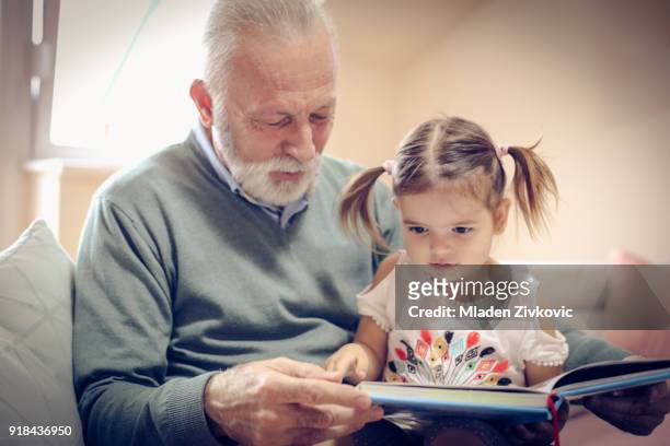 time for grandchild. - reading old young stock pictures, royalty-free photos & images
