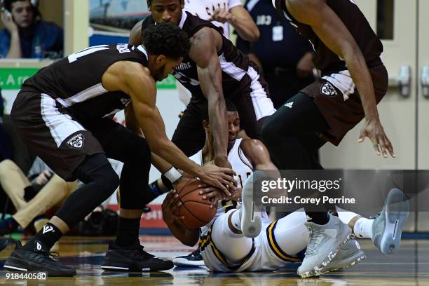 Amar Stukes of the La Salle Explorers is surrounded by Courtney Stockard, Izaiah Brockington and Tshiefu Ngalakulondi of the St. Bonaventure Bonnies...