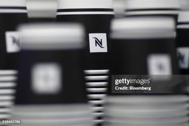 Nespresseo cups stand stacked ahead of a news conference announcing the company's full year results in Vevey, Switzerland, on Thursday, Feb. 15,...