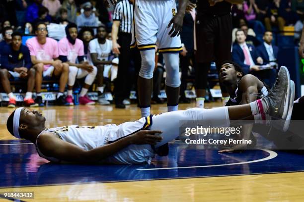 Isiah Deas of the La Salle Explorers and Izaiah Brockington of the St. Bonaventure Bonnies watch the ball after hitting the floor after colliding in...