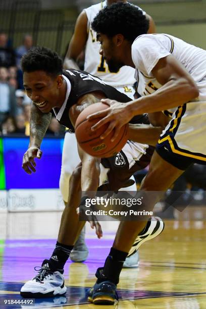 Jaylen Adams of the St. Bonaventure Bonnies reaches in on Pookie Powell of the La Salle Explorers during the first half at Tom Gola Arena on February...