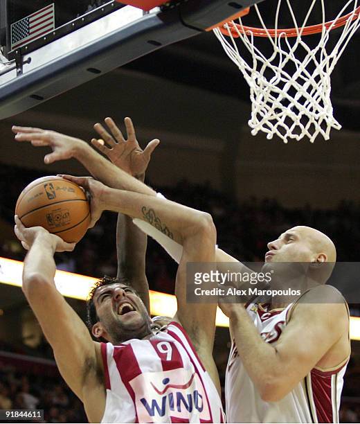Ioannis Bourousis, #9 of Olympiacos Piraeus competes with Zydrunas Ilgauskas, #11 of Cleveland Cavaliers during the Euroleague American Tour match...