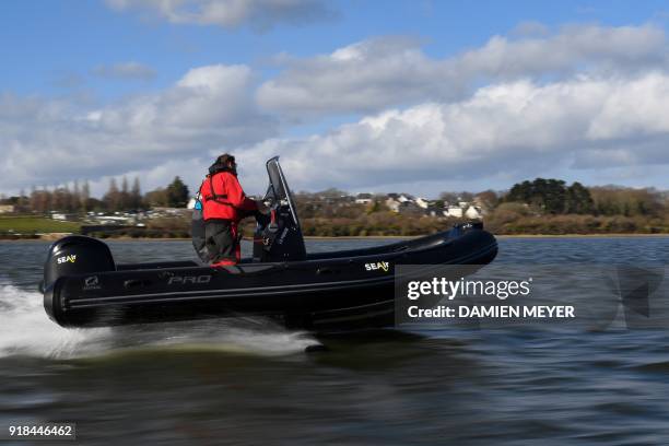 Rigid inflatable boat equiped with adjustable foils, designed by Lorient-based company "SeAir", flies over water on February 13, 2018 off the coast...