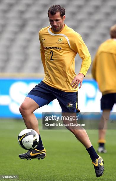 Lucas Neill of the Socceroos controls the ball at an Australian Socceroos training session at at Etihad Stadium on October 13, 2009 in Melbourne,...