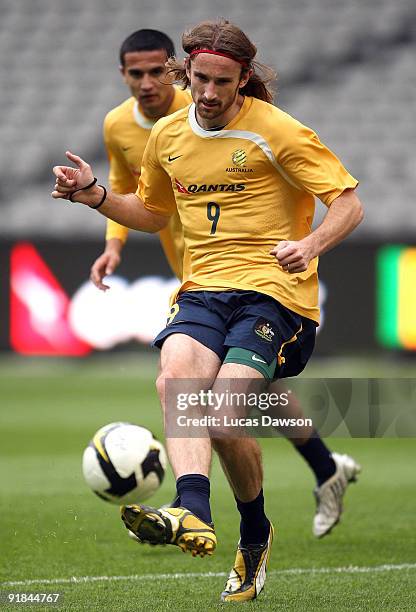 Joshua Kennedy of the Socceroos kicks the ball at an Australian Socceroos training session at at Etihad Stadium on October 13, 2009 in Melbourne,...