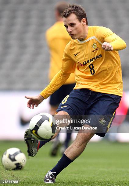 Luke Wilkshire of the Socceroos kicks the ball at an Australian Socceroos training session at at Etihad Stadium on October 13, 2009 in Melbourne,...