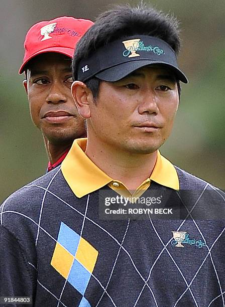 International team member Y.E. Yang of South Korea walks up to the 12th fee box after US team member Tiger Woods teed off during the final round...