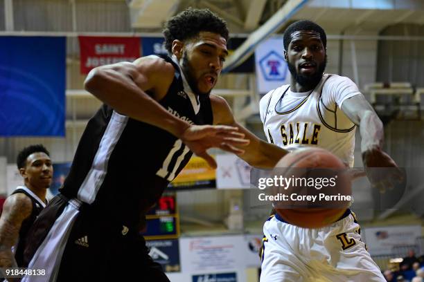 Courtney Stockard of the St. Bonaventure Bonnies knocks the ball out of bounds against B.J. Johnson of the La Salle Explorers during the second half...