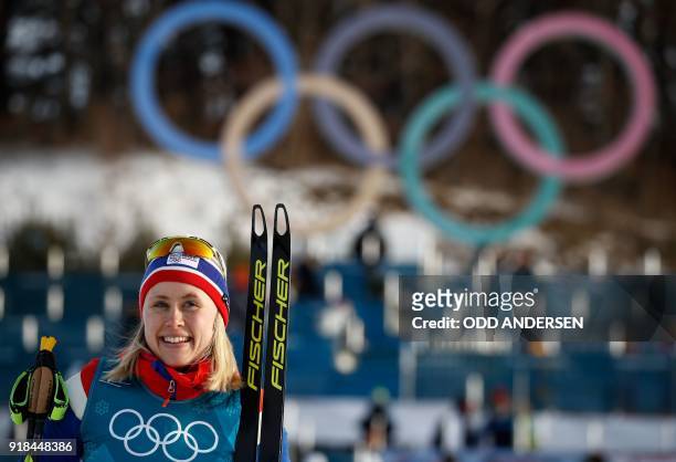 Gold medallist Norway's Ragnhild Haga celebrates during the victory ceremony at the end of the women's 10km freestyle cross-country competition at...