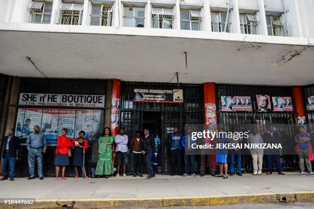 Members of Zimbabwe's opposition party 'Movement for Democratic Change' gather outside Harvest House, the party's headquarters, in Harare on February...