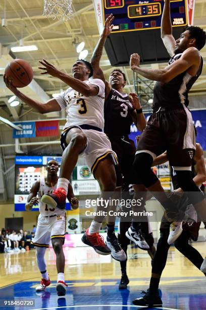 Jamir Moultrie of the La Salle Explorers drives to the basket against Jaylen Adams and LaDarien Griffin of the St. Bonaventure Bonnies during the...
