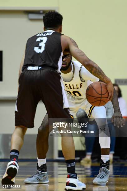 Johnson of the La Salle Explorers looks to defend as Jaylen Adams of the St. Bonaventure Bonnies dribbles during the second half at Tom Gola Arena on...