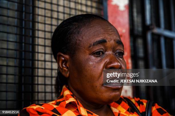 Woman reacts after the announcement of the death of Morgan Tsvangirai as members of his opposition party 'Movement for Democratic Change' gather...