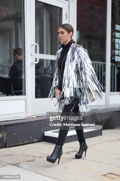 Guest is seen on the street attending Leanne Marshall during New York Fashion Week wearing a silver fringe jacket on February 14, 2018 in New York...