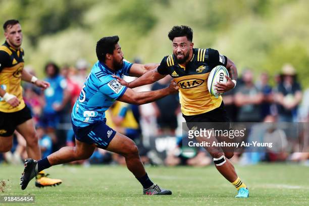 Matt Proctor of the Hurricanes fends against George Moala of the Blues during the Super Rugby trial match between the Blues and the Hurricanes at...