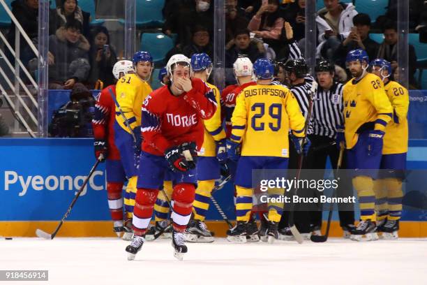 Kristian Forsberg of Norway leaves the ice with a bloody nose during the Men's Ice Hockey Preliminary Round Group C game between Norway and Sweden on...