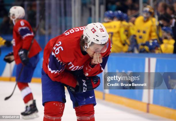 Kristian Forsberg of Norway leaves the ice with a bloody nose during the Men's Ice Hockey Preliminary Round Group C game between Norway and Sweden on...